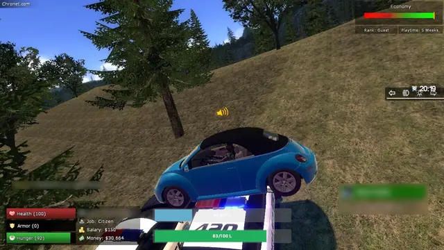 A blue Beetle convertible sitting on top of a police car on a hillside