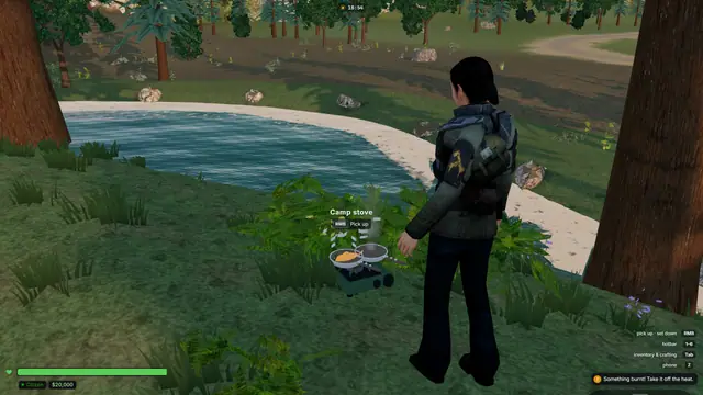 A player cooking fish and eggs in pans on a camp stove by a lake